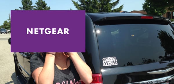 A soccer mom hides her face with the NETGEAR logo.